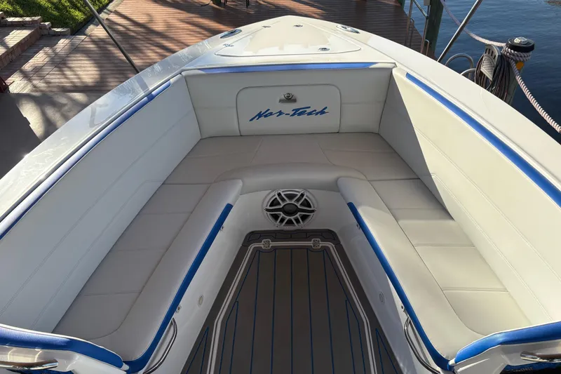 Slide: The Image of 2023 Nor-Tech 390 Sport Center Console boat with spacious seating and sleek design. - 8