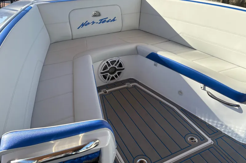 Slide: The Image of 2023 Nor-Tech 390 Sport Center Console interior with cushioned seating and speaker. - 9