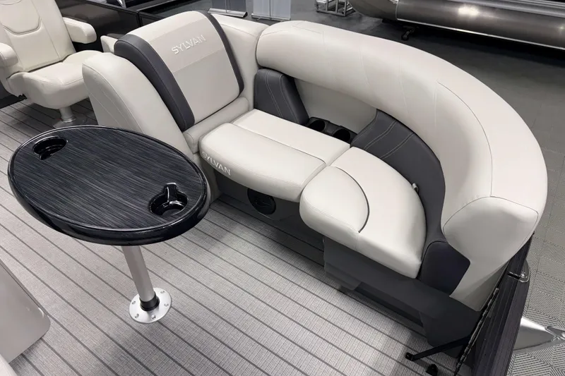 Slide: The Image of Luxurious seating on 2026 Sylvan Mirage 8520 CLZ DH pontoon boat with sleek table design. - 2