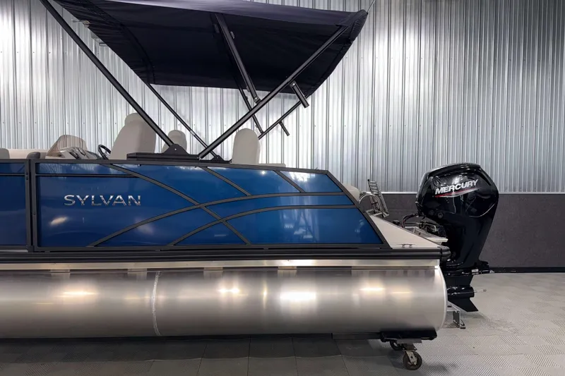 Slide: The Image of 2026 Sylvan Mirage 8520 CLZ DH pontoon boat with Mercury outboard motor in showroom. - 22