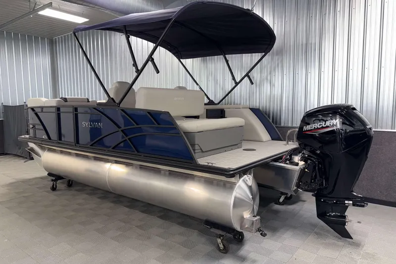 Slide: The Image of 2026 Sylvan Mirage 8520 CLZ DH pontoon boat with Mercury outboard in a showroom. - 24