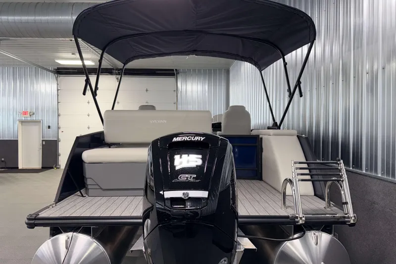 Slide: The Image of 2026 Sylvan Mirage 8520 CLZ DH pontoon boat with Mercury outboard motor in a showroom. - 25