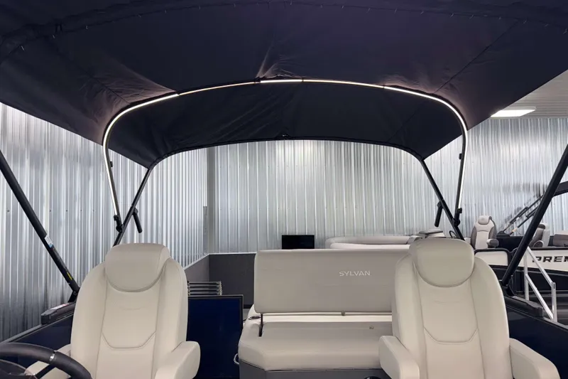 Slide: The Image of 2026 Sylvan Mirage 8520 CLZ DH pontoon boat interior with canopy and seating. - 26