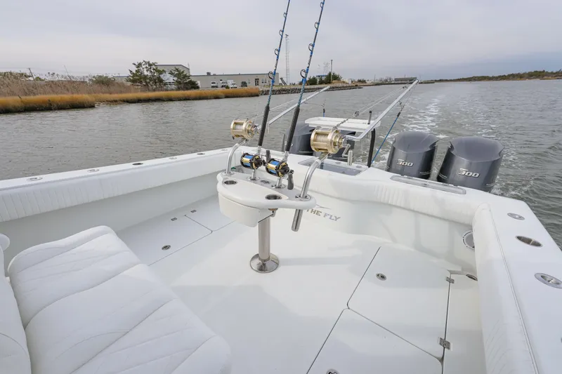 Slide: The Image of 2018 Freeman 37 VH fishing boat with rods and triple 300 engines on a calm waterway. - 11