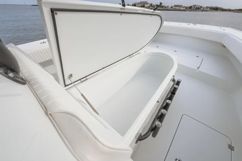 Slide: The Image of Open storage compartment on 2018 Freeman 37 VH boat, near water. - 16
