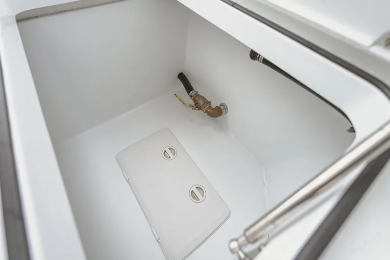 Slide: The Image of Freeman 37 VH 2018 boat compartment with plumbing and storage hatch. - 33