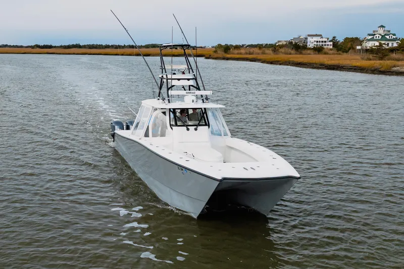 Slide: The Image of 2018 Freeman 37 VH boat cruising on a calm river with scenic background. - 4