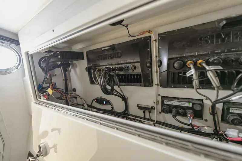 Slide: The Image of Electrical panel inside a 2018 Freeman 37 VH boat, featuring Simrad equipment and wiring. - 46
