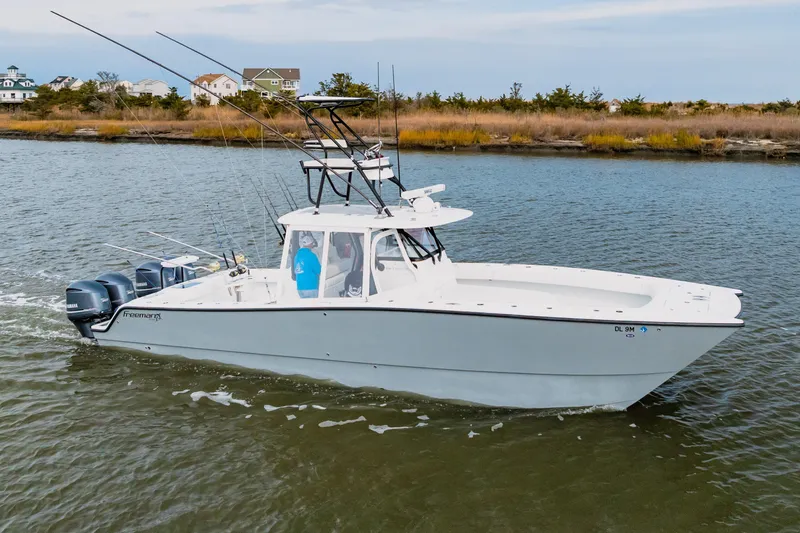 Slide: The Image of 2018 Freeman 37 VH boat cruising on a calm river with fishing rods. - 5