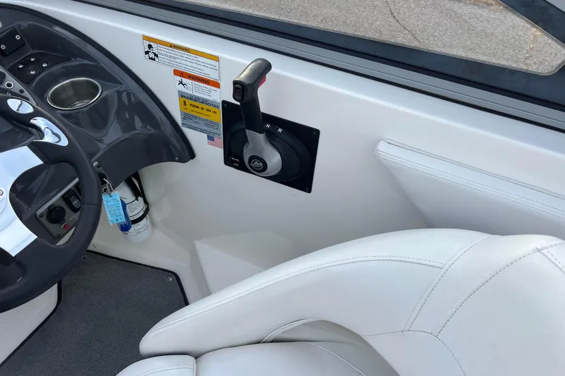 Slide: The Image of Interior of 2013 Larson LX 205S IO boat showing steering wheel and throttle controls. - 11