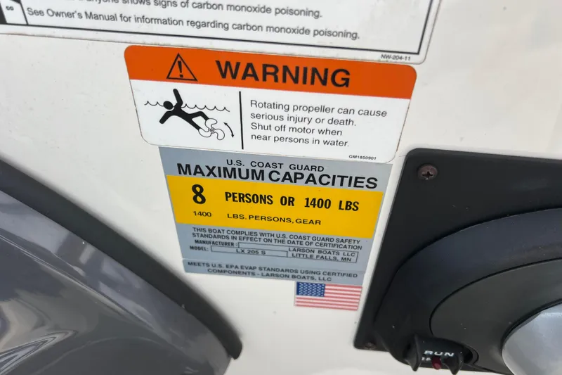 Slide: The Image of Warning label on 2013 Larson LX 205S IO boat, indicating maximum capacity of 8 persons or 1400 lbs. - 13
