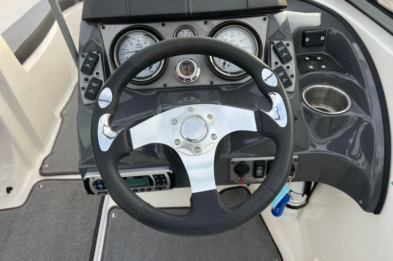 Slide: The Image of Steering wheel and dashboard of 2013 Larson LX 205S IO boat. - 16