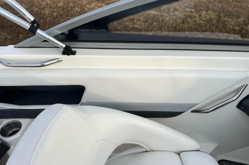 Slide: The Image of Interior of 2013 Larson LX 205S IO boat with white seating and sleek design. - 20