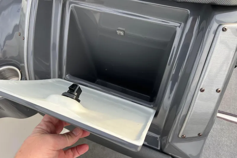 Slide: The Image of Open storage compartment on a 2013 Larson LX 205S IO boat. - 23