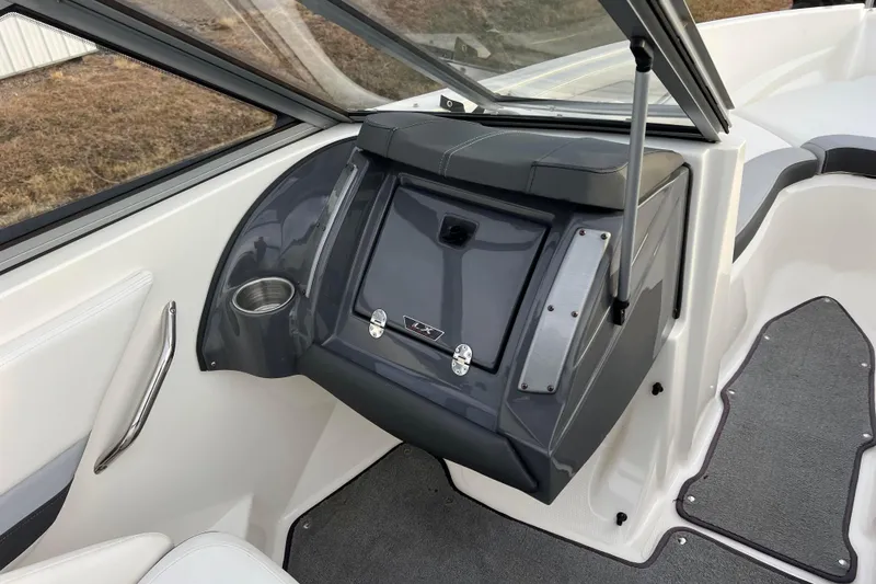 Slide: The Image of Interior of 2013 Larson LX 205S IO boat, featuring dashboard and cup holder. - 25