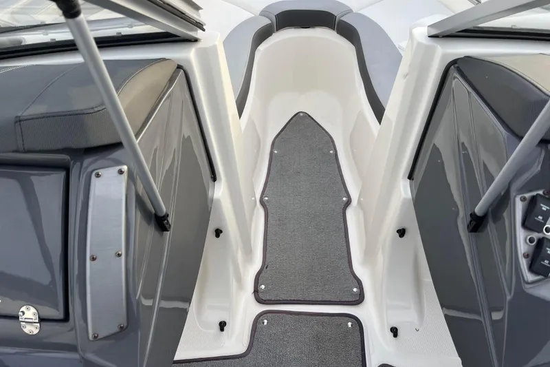 Slide: The Image of Interior view of 2013 Larson LX 205S IO boat, featuring gray seating and carpeted flooring. - 3