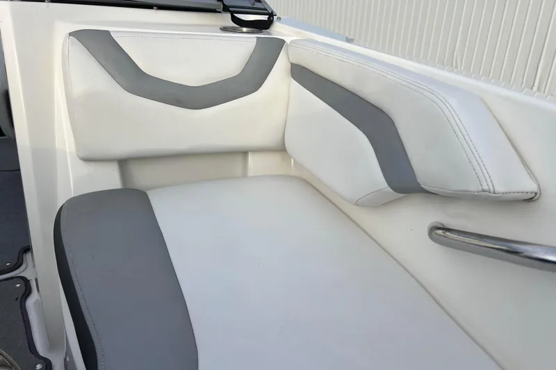 Slide: The Image of 2013 Larson LX 205S IO boat interior with white and gray cushioned seating. - 32