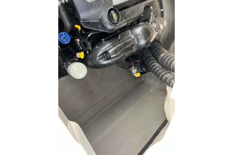 Slide: The Image of Engine compartment of a 2013 Larson LX 205S IO boat, showing mechanical components. - 35
