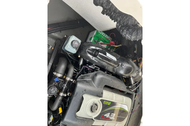 Slide: The Image of Engine compartment of a 2013 Larson LX 205S IO boat, featuring a 4.3 MPI motor. - 36