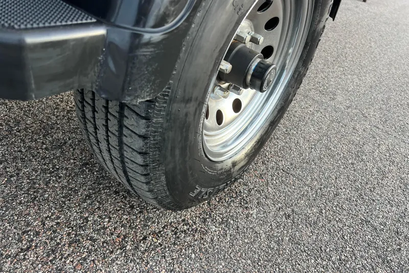 Slide: The Image of Close-up of a 2013 Larson LX 205S IO trailer tire on asphalt. - 40