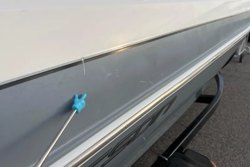 Slide: The Image of 2013 Larson LX 205S IO boat with minor scratches on the side hull. - 42