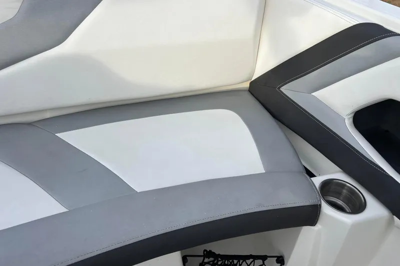 Slide: The Image of 2013 Larson LX 205S IO boat interior with gray and white seating and cup holder. - 5