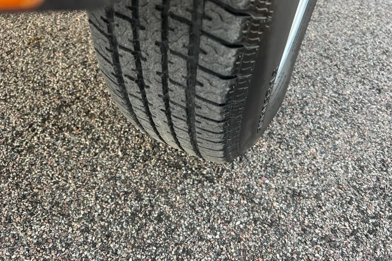 Slide: The Image of Close-up of a tire on a 2013 Larson LX 205S IO boat trailer. - 53