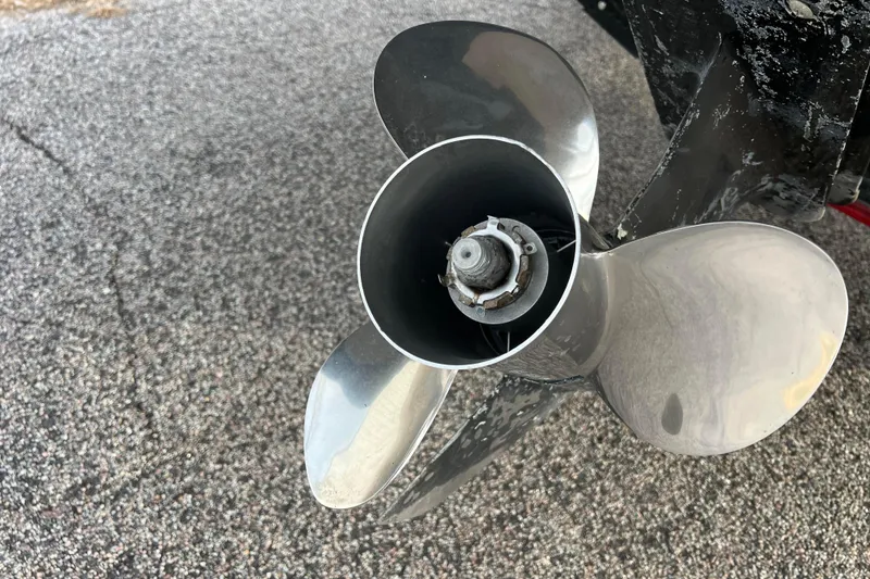 Slide: The Image of Close-up of a 2013 Larson LX 205S IO boat propeller on a textured surface. - 56