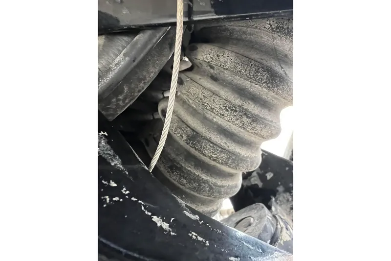 Slide: The Image of Close-up of 2013 Larson LX 205S IO boat's engine component with visible wear. - 57