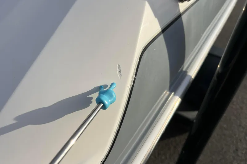 Slide: The Image of Close-up of a 2013 Larson LX 205S IO boat with a small hull scratch. - 58