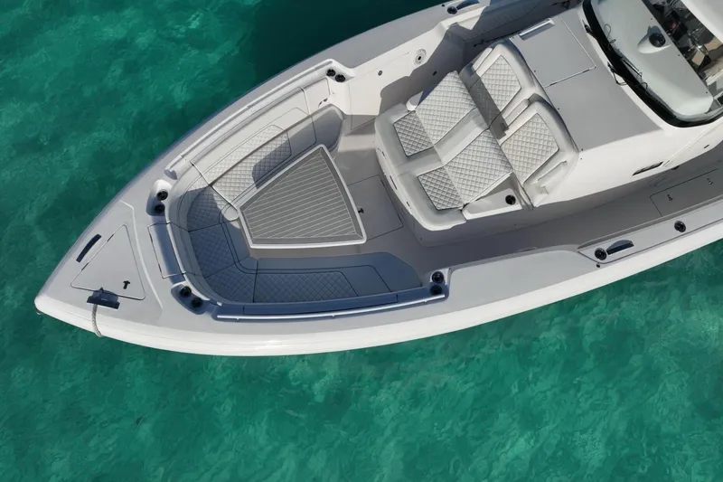 Slide: The Image of 2023 Intrepid 427 Nomad SE cruising on blue ocean with city skyline in background. - 11