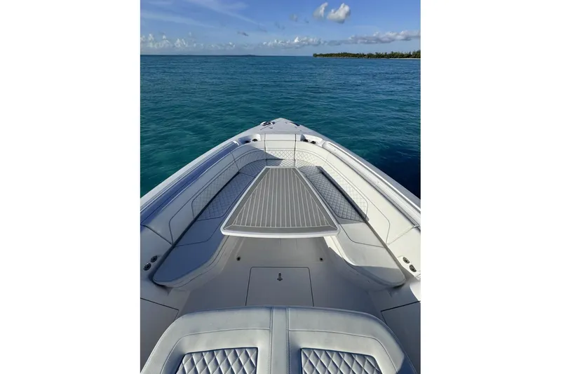 Slide: The Image of 2023 Intrepid 427 Nomad SE boat on open ocean under blue sky. - 14