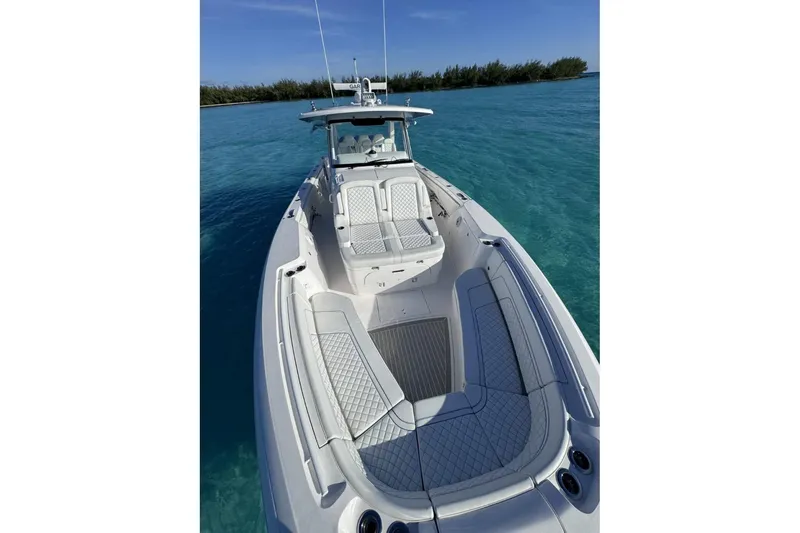 Slide: The Image of 2023 Intrepid 427 Nomad SE boat cruising on blue ocean near city skyline. - 17