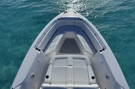 Slide: The Image of 2023 Intrepid 427 Nomad SE boat on open water with city skyline. - 19