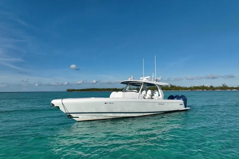 Slide: The Image of 2023 Intrepid 427 Nomad SE cruising on blue ocean near city skyline. - 2