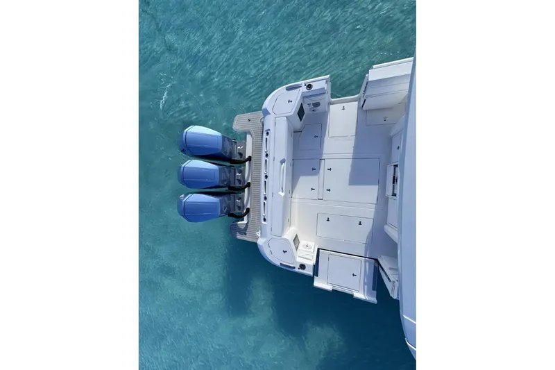 Slide: The Image of 2023 Intrepid 427 Nomad SE boat cruising on open ocean under blue sky. - 20