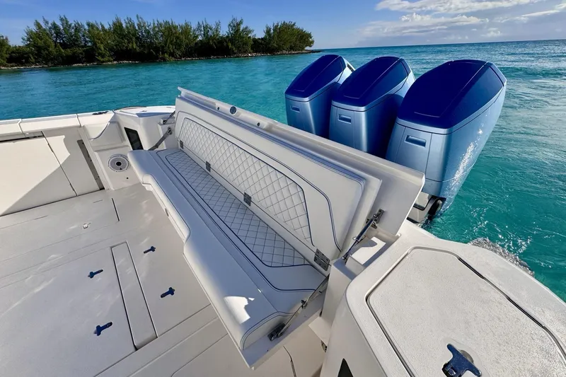 Slide: The Image of 2023 Intrepid 427 Nomad SE boat on open ocean, featuring luxurious seating and clear blue skies. - 22