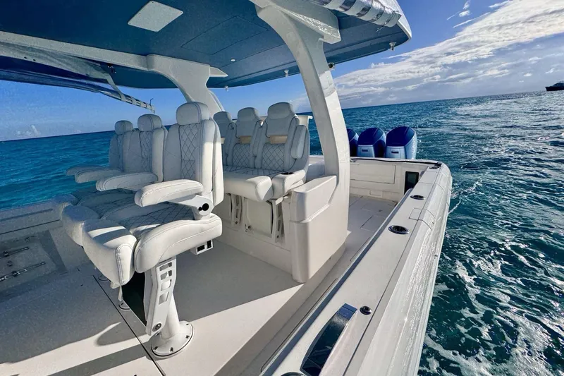Slide: The Image of 2023 Intrepid 427 Nomad SE boat interior with open storage compartments, ocean view. - 23