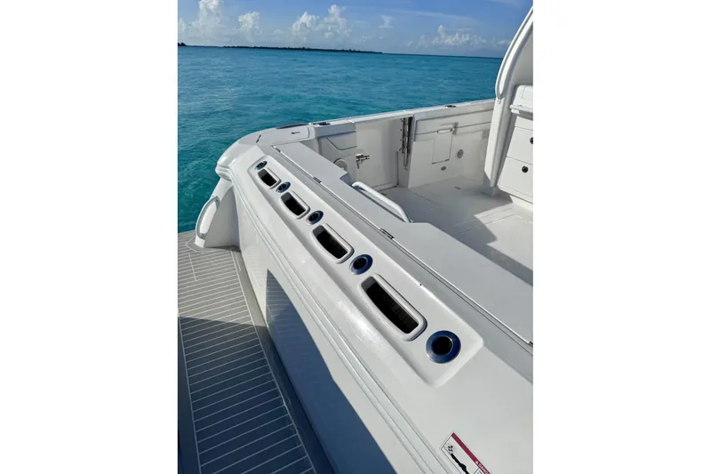 Slide: The Image of 2023 Intrepid 427 Nomad SE boat with open storage compartment, ocean view background. - 26