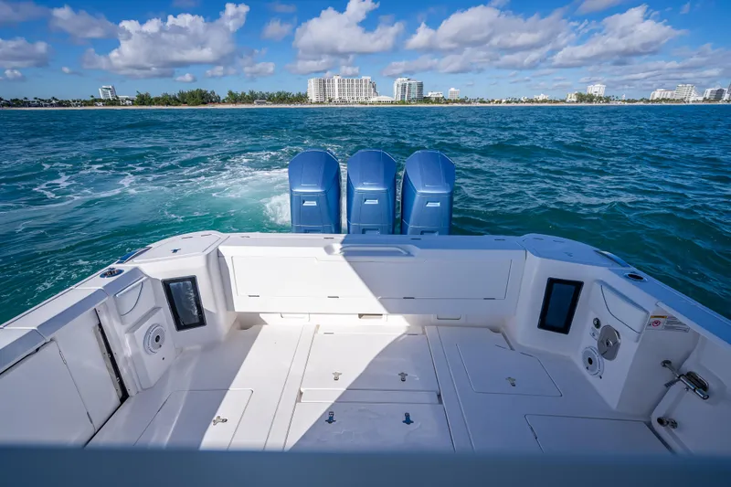 Slide: The Image of 2023 Intrepid 427 Nomad SE boat with triple engines on open water. - 38