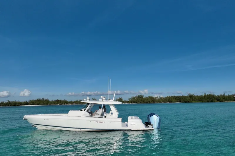 Slide: The Image of 2023 Intrepid 427 Nomad SE cruising on open ocean with city skyline in background. - 4