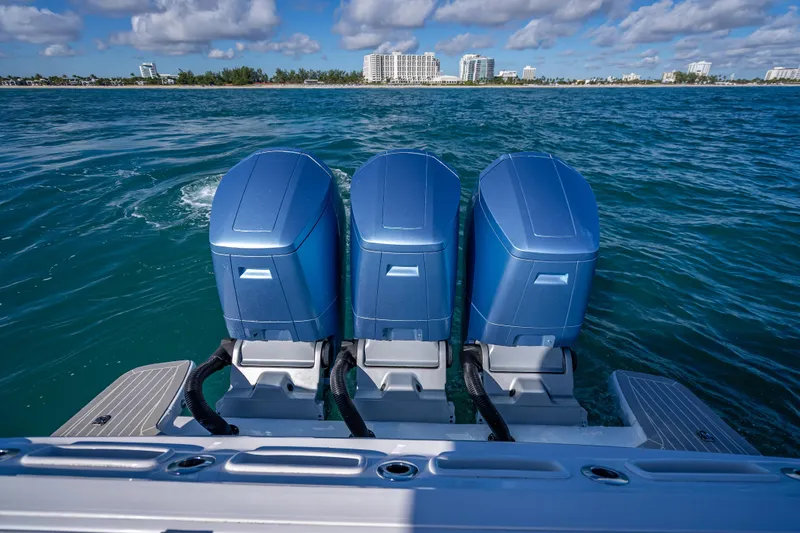 Slide: The Image of 2023 Intrepid 427 Nomad SE with triple outboard engines on open water. - 43