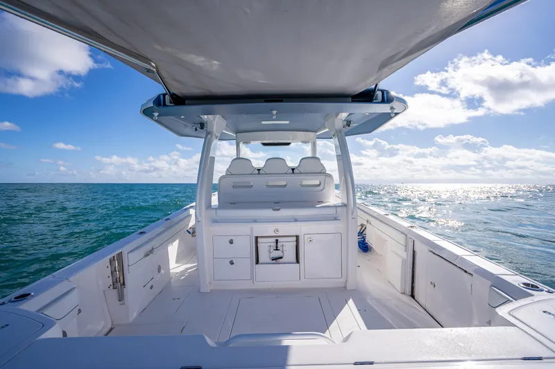 Slide: The Image of 2023 Intrepid 427 Nomad SE boat on open sea under clear blue sky. - 45