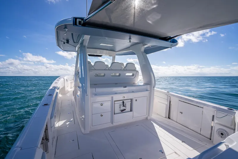 Slide: The Image of 2023 Intrepid 427 Nomad SE boat on open sea under clear blue sky. - 46