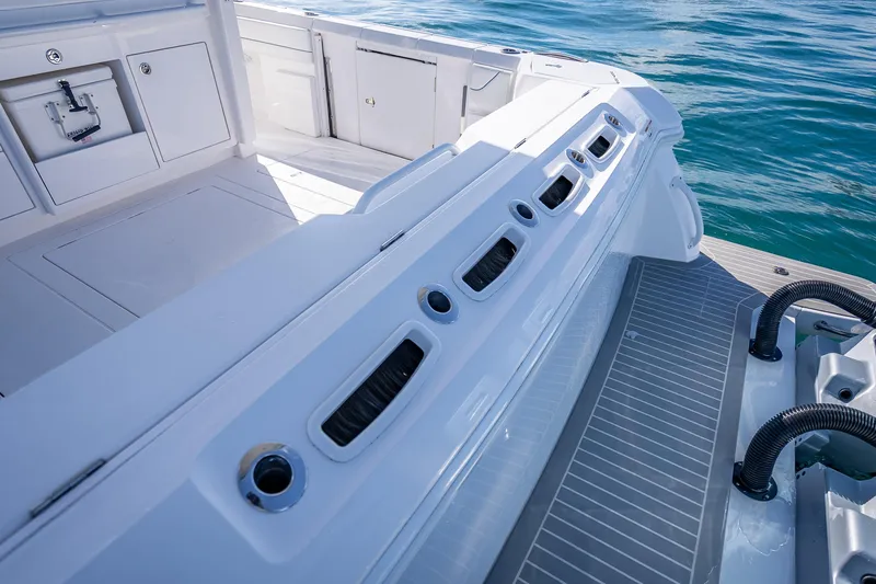 Slide: The Image of 2023 Intrepid 427 Nomad SE boat deck with sleek design and ocean backdrop. - 48