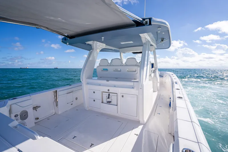 Slide: The Image of 2023 Intrepid 427 Nomad SE boat on open sea under clear blue sky. - 49