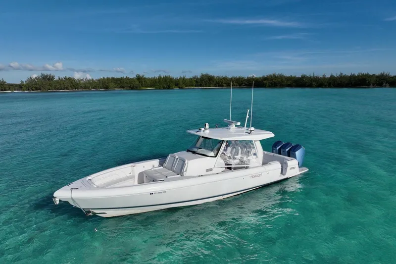 Slide: The Image of 2023 Intrepid 427 Nomad SE cruising on blue ocean with city skyline in background. - 5