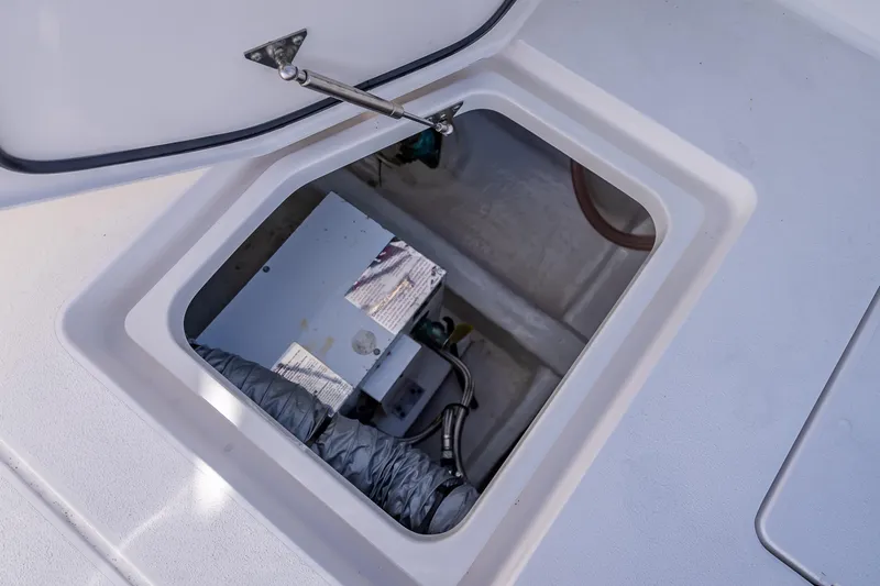 Slide: The Image of Open hatch of 2023 Intrepid 427 Nomad SE boat, revealing internal compartment. - 50