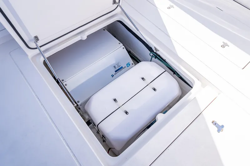 Slide: The Image of Open storage compartment on 2023 Intrepid 427 Nomad SE boat, showcasing internal equipment. - 51