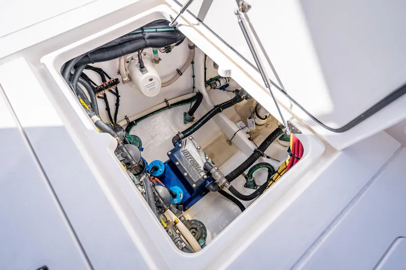 Slide: The Image of Engine compartment of 2023 Intrepid 427 Nomad SE, showcasing internal components and wiring. - 52